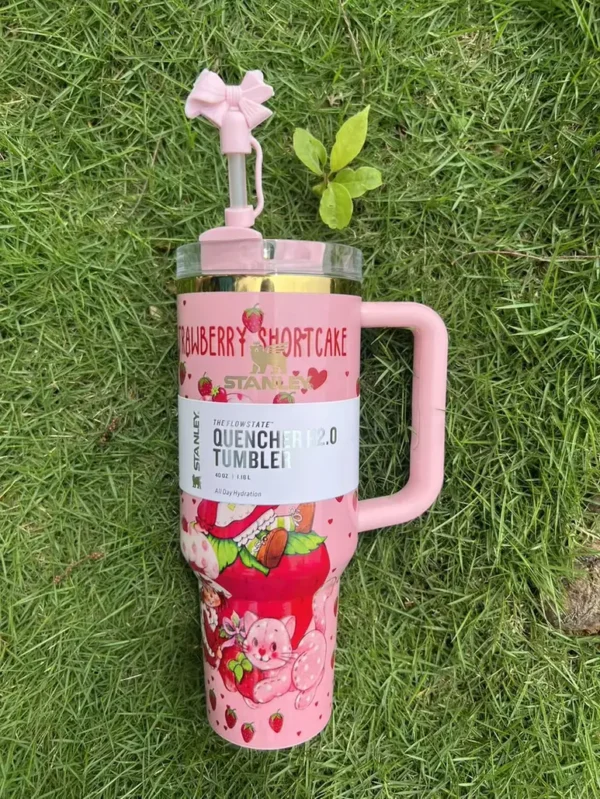 Pink tumbler with strawberry-inspired artwork Pink strawberry-inspired tumbler with bow straw topper